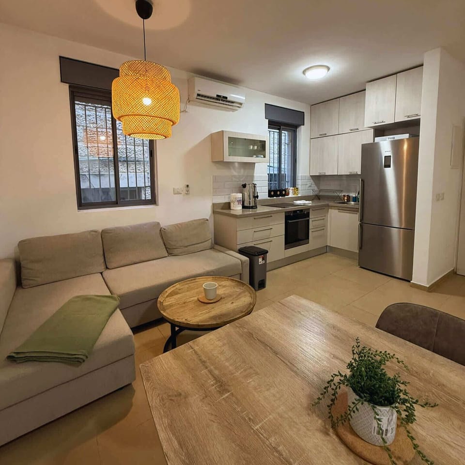 Open plan kitchen and dining area with modern appliances, clean design, and direct access to the bedroom and bathroom.