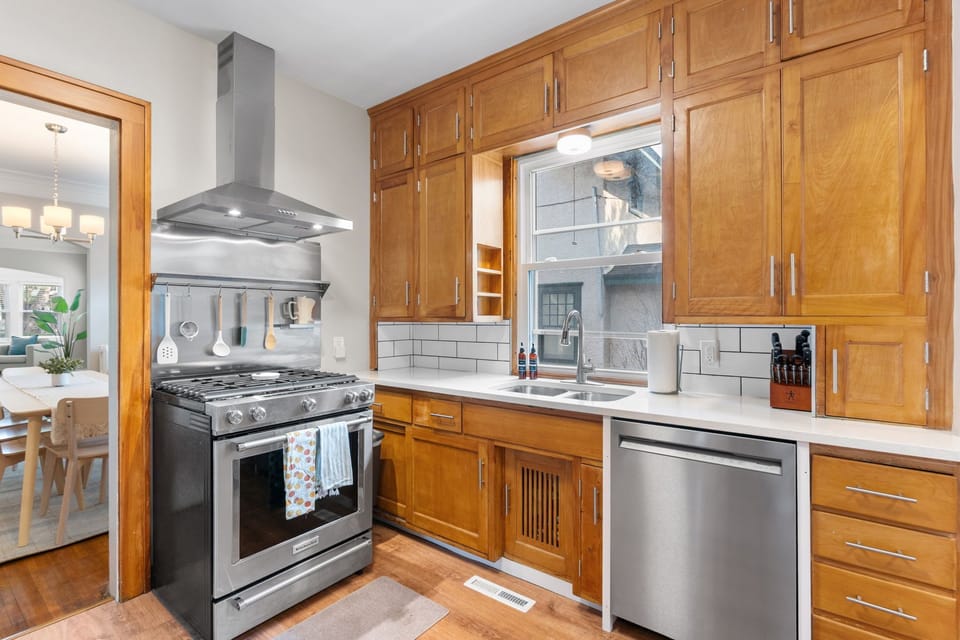 Your gourmet kitchen awaits with rich wood cabinetry, stainless steel appliances, and subway tile backsplash—perfect for creating memorable meals during your stay.