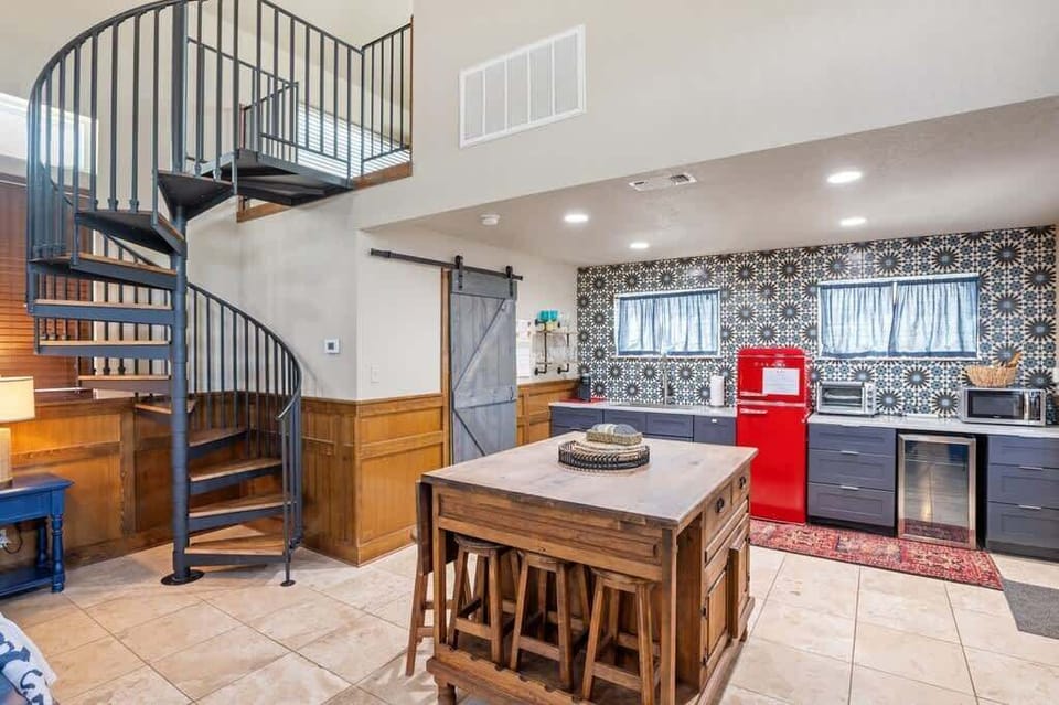 Charming Kitchenette & Dining: Delight in vibrant decor, a pop of red, and stylish dining space!