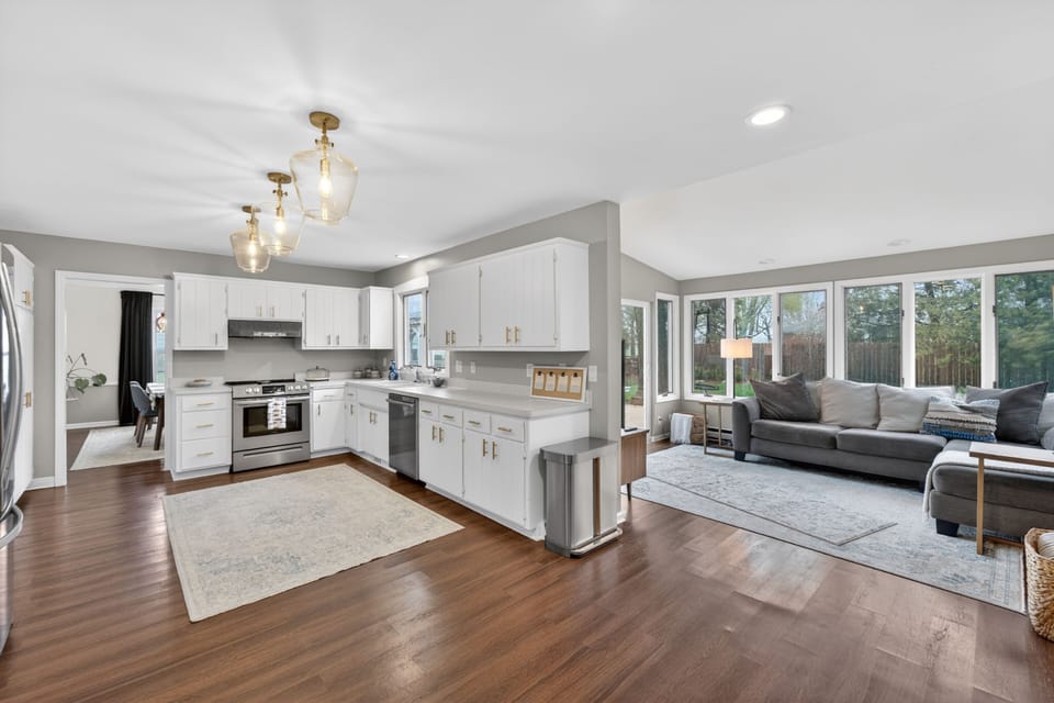 Kitchen leads to beautiful sunroom that opens onto deck and backyard