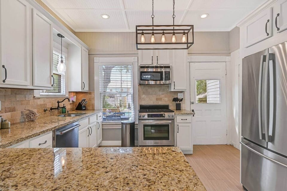 Fully stocked kitchen with all appliances to accommodate everything small or large groups could need to prepare meals or entertain outside by the pool, picnic tables, BBQ pit, fire pit, inside, relaxing on one of the balconies, or front porch.  
