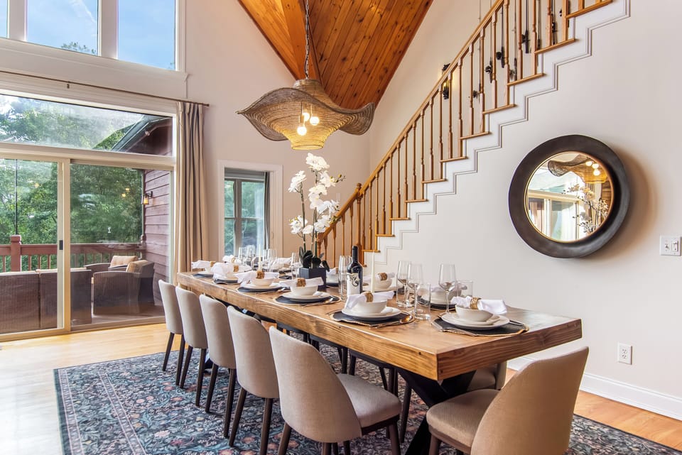 Gather at the stunning 12-seat dining table under soaring wood ceilings.