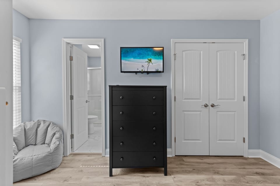 Bunkroom with beanbag chairs and Smart TV