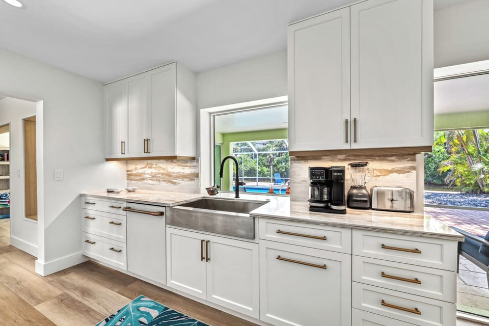 A deep stainless steel French country sink makes cleanup a breeze—with a view to match.