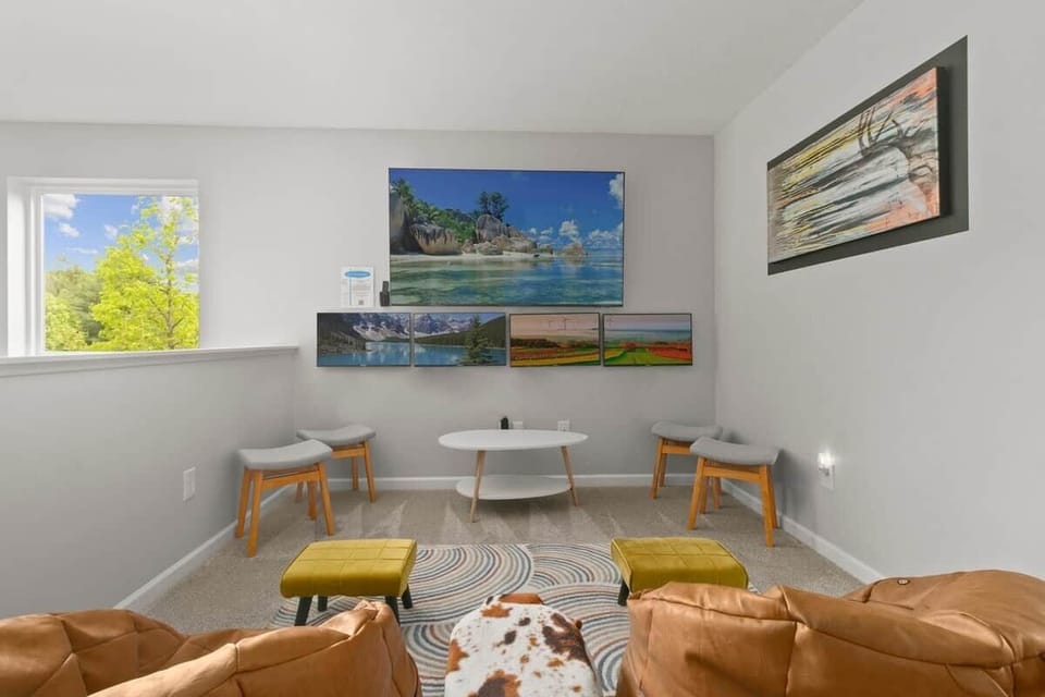 Fun upstairs lounge and game area designed for kids, families, movie nights, and relaxing after beach days.