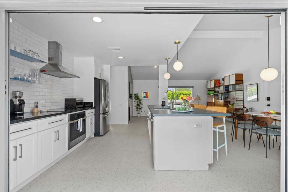Kitchen island seating overlooking private pool & patio