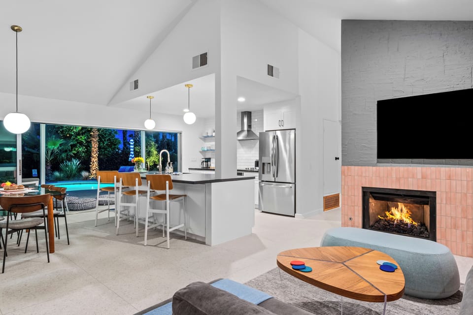 Open-concept living with fireplace & chef's kitchen