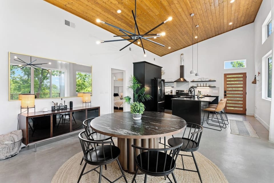 {Great Room} Gather under soaring wood ceilings with dining for 7, an open kitchen, and mountain views just beyond the panes of glass,
