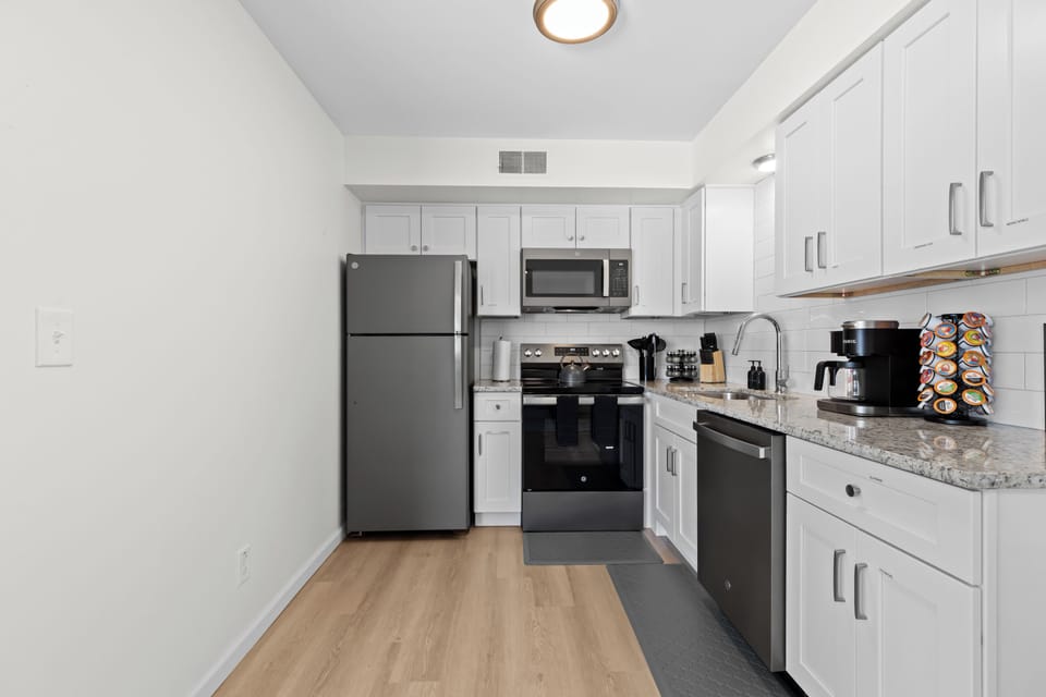 Modern kitchen equipped with stainless steel appliances and sleek cabinetry.