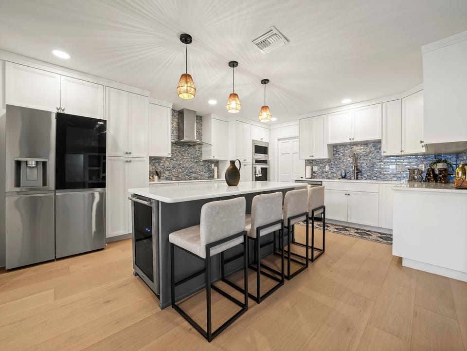 Welcome to your dream kitchen! Fully stocked with high-end appliances and featuring a large island with high seating — perfect for morning coffee, snacks, or sharing stories while you cook.
