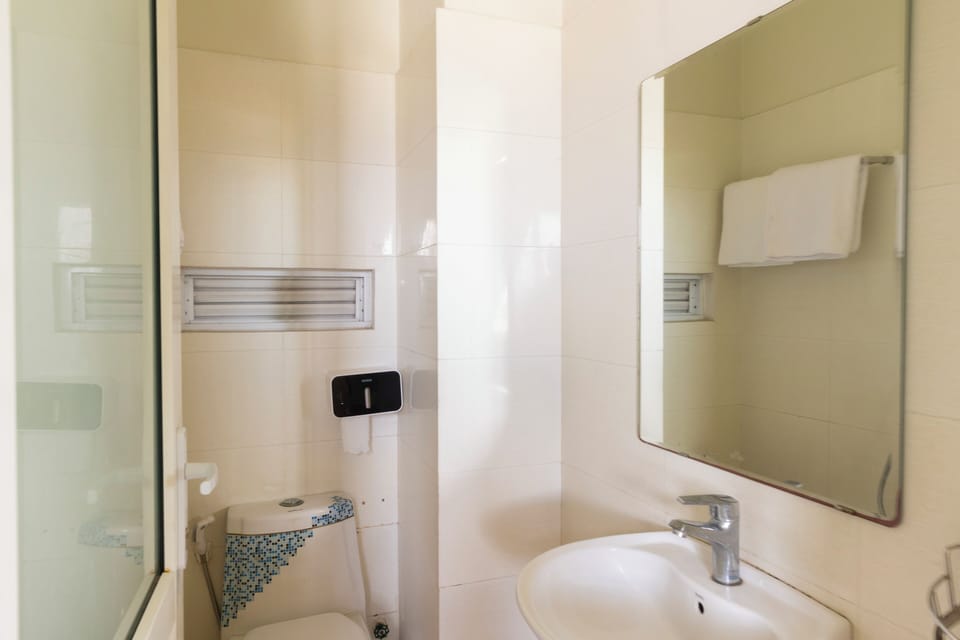 Standard Room | Bathroom | Hair dryer, slippers, towels, toilet paper