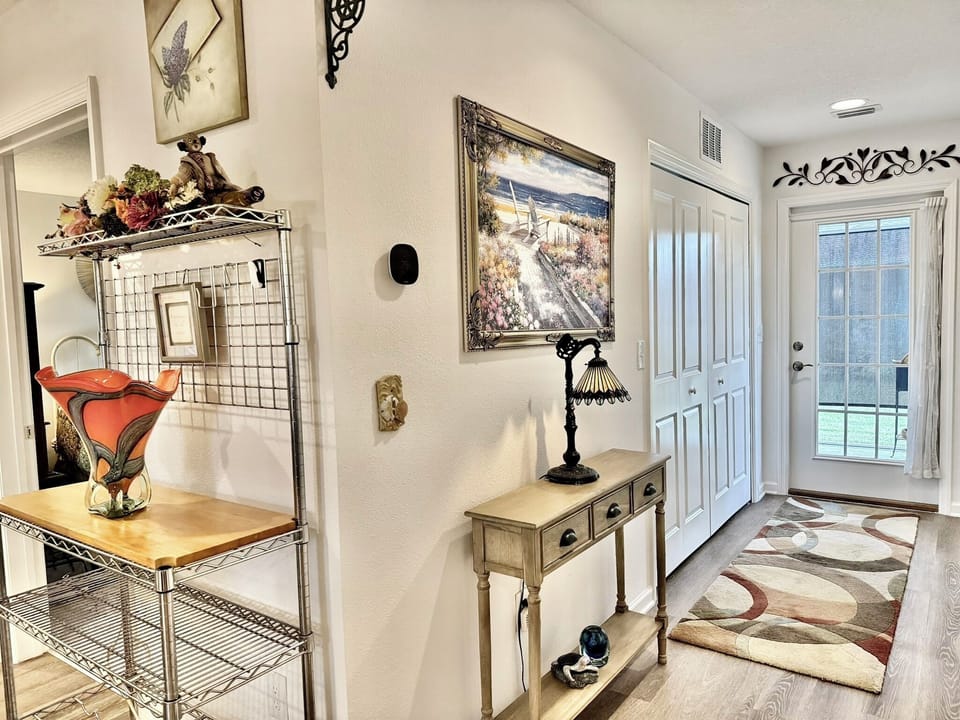 The Hallway on the Right Leads to Laundry (left) Lanai (Center) and Master Bedroom (right)