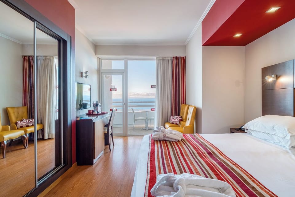 Sip coffee by the balcony while the coastline glows outside.