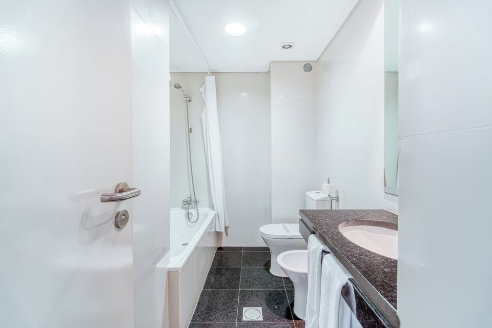 Refresh easily with a deep bathtub and bright vanity lighting.