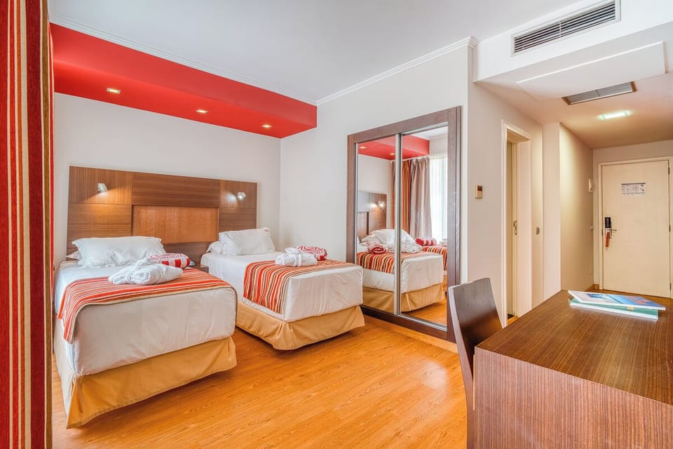Unwind in a bright twin bedroom with crisp linens.