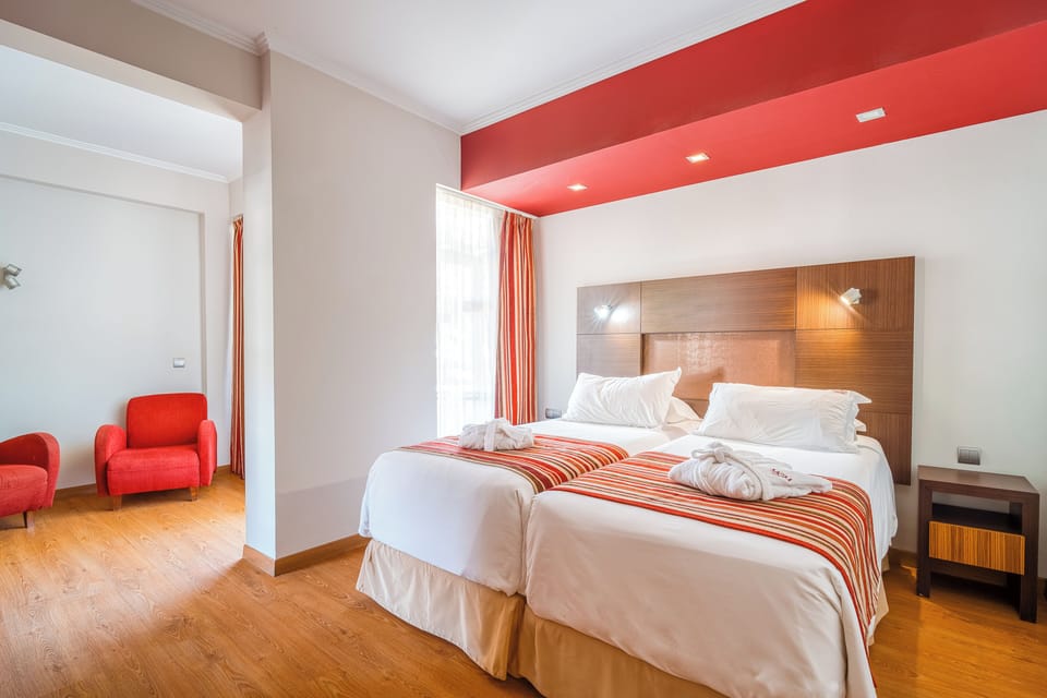 Unwind in crisp linens beneath warm, modern accent lighting.