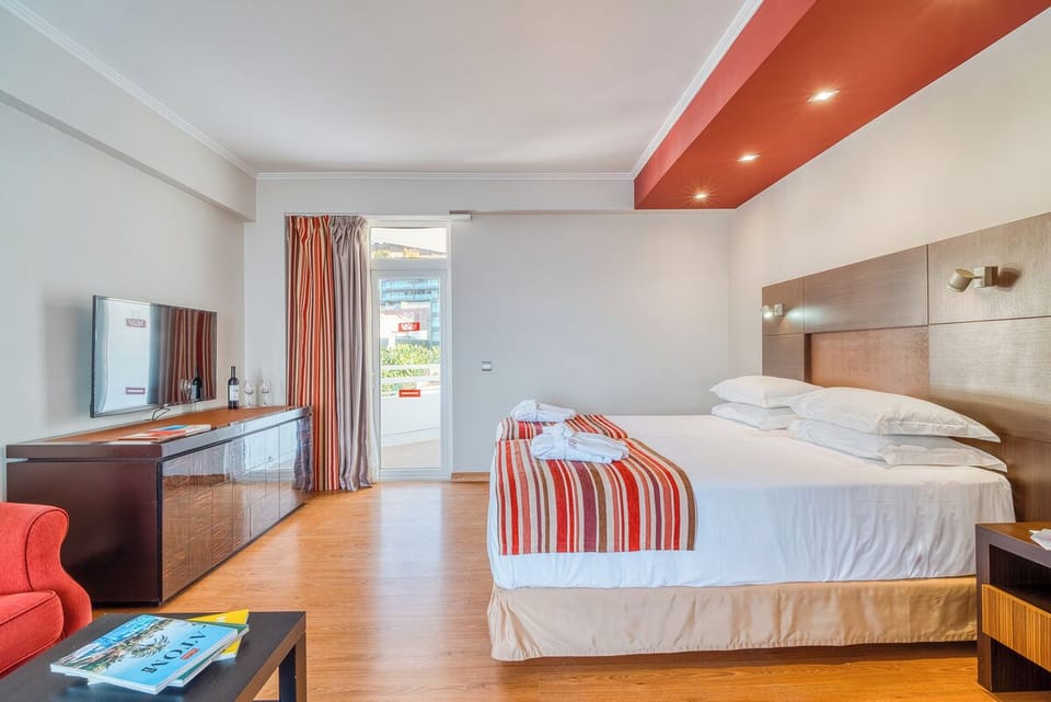 Stretch out in a roomy layout with TV and calm tones.