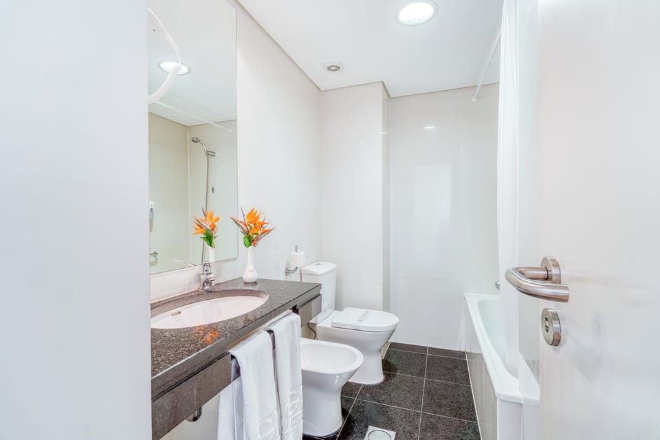 Feel pampered at the sleek vanity with fresh towels.