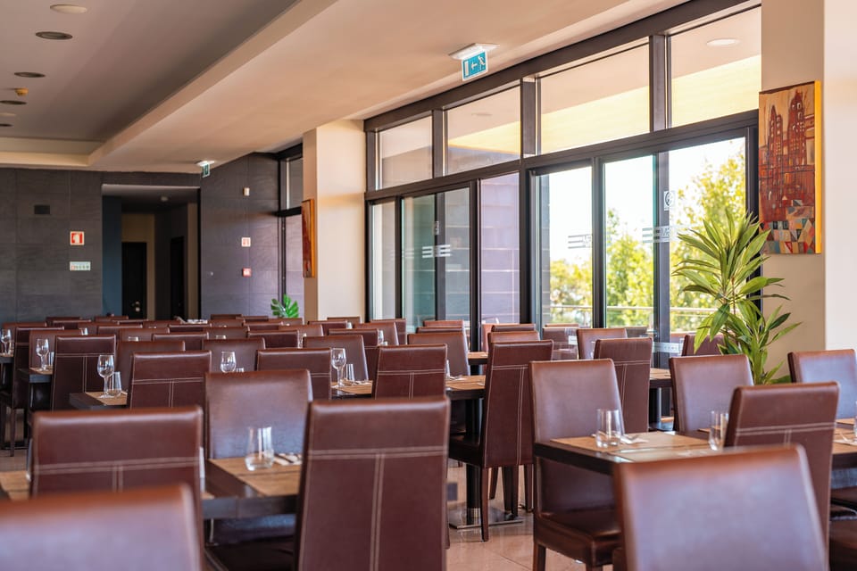 Gather for relaxed meals in a spacious, sunlit dining hall.