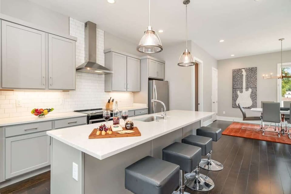 2nd Floor: Fully Equipped Kitchen with stainless steel appliances and a spacious island with seating for 4 guests.