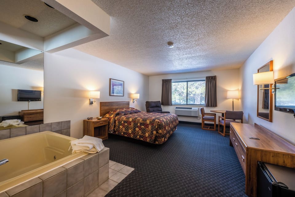 Unplug from the everyday hustle and immerse yourself in a haven of serenity. Nestled in a serene spot where nature meets luxury, our queen bed whirlpool suite promises an experience unlike any other.

From the moment you step through the door, you'll feel your tensions melt away. Sink into the plush comfort of a queen-sized bed that awaits to cradle you in relaxation. Or, let y...