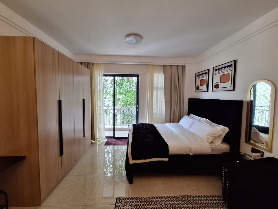 Queen bed with orthopedic matress and pillows , and a sizeable wardrobe 