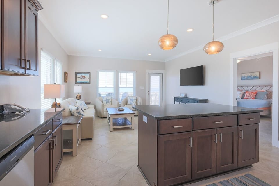 Open living space featuring modern furnishings, a large TV, and inviting beach views from the three bedroom beach house