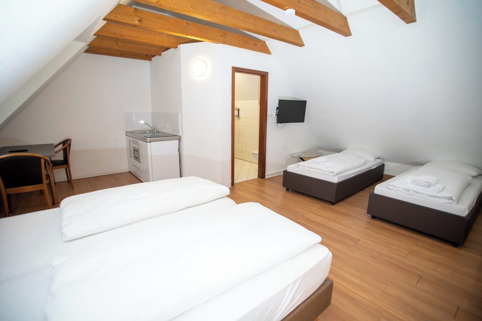 Family Quadruple Room, Courtyard View | Desk, laptop workspace, soundproofing, iron/ironing board