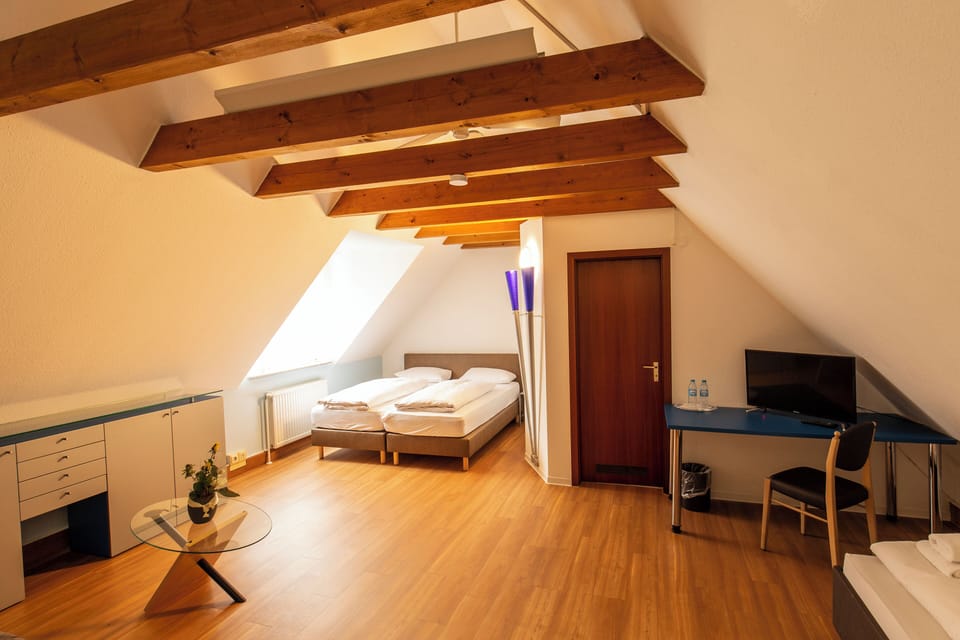 Family Quadruple Room, Courtyard View | Desk, laptop workspace, soundproofing, iron/ironing board