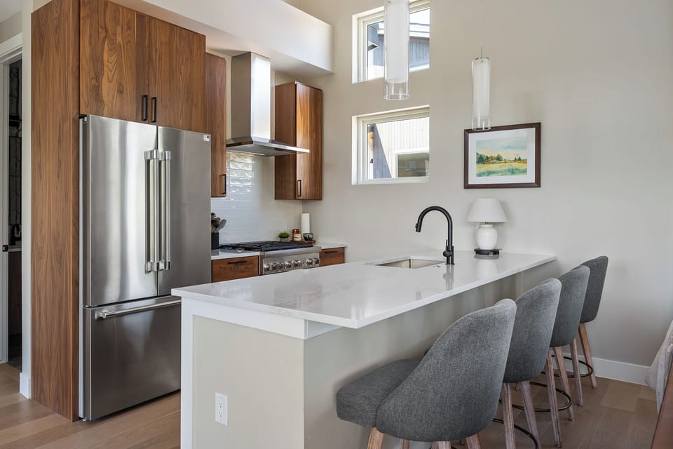- Stylish kitchen with wood cabinets and sleek counters   - Stainless steel appliances and modern fixtures   - Bar seating for casual meals or morning coffee