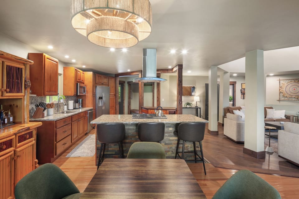 Amply stocked chef’s-inspired kitchen and open dining area. Ideal for cooking, entertaining, and gathering after days spent exploring Glacier National Park, hiking, fishing, or skiing Whitefish Resort.