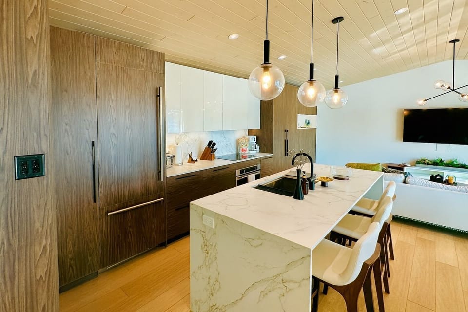 Modern kitchen with sleek cabinetry, modern island, and pendant lighting—perfect for preparing lakeside feasts.