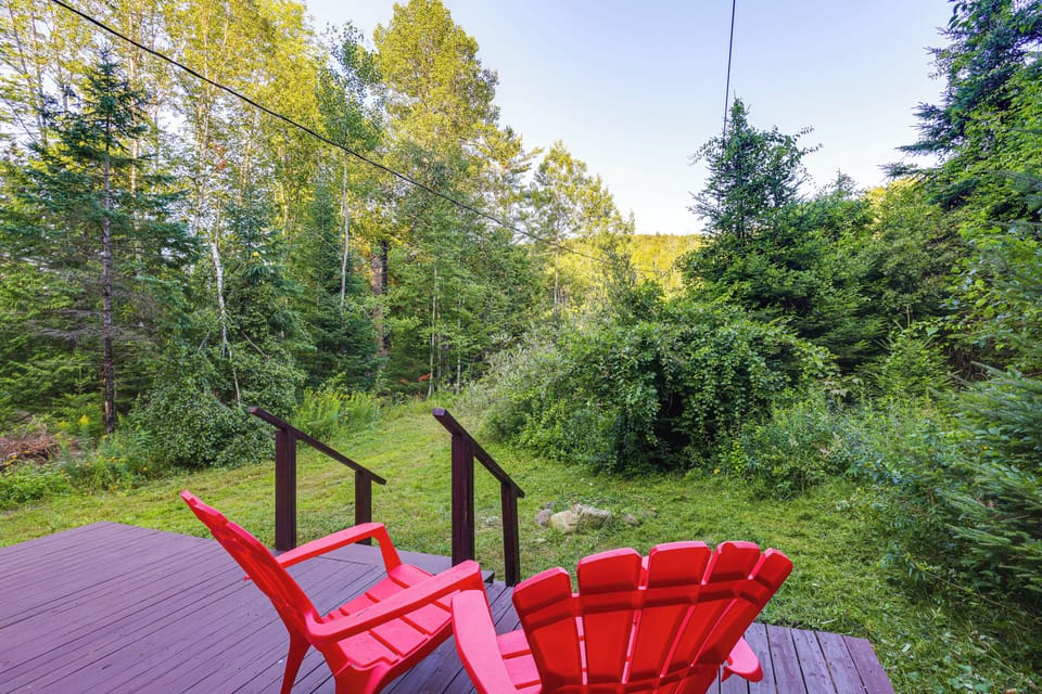 Cabin Exterior | Front Porch w/ Seating | Wooded Surroundings