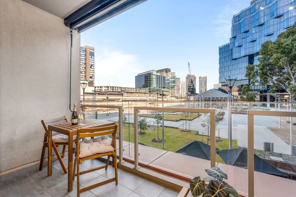 Private balcony with outdoor dining set, city skyline views, and green park outlook. A perfect spot to enjoy morning coffee, sunset drinks, or a relaxed meal with fresh air and urban scenery.