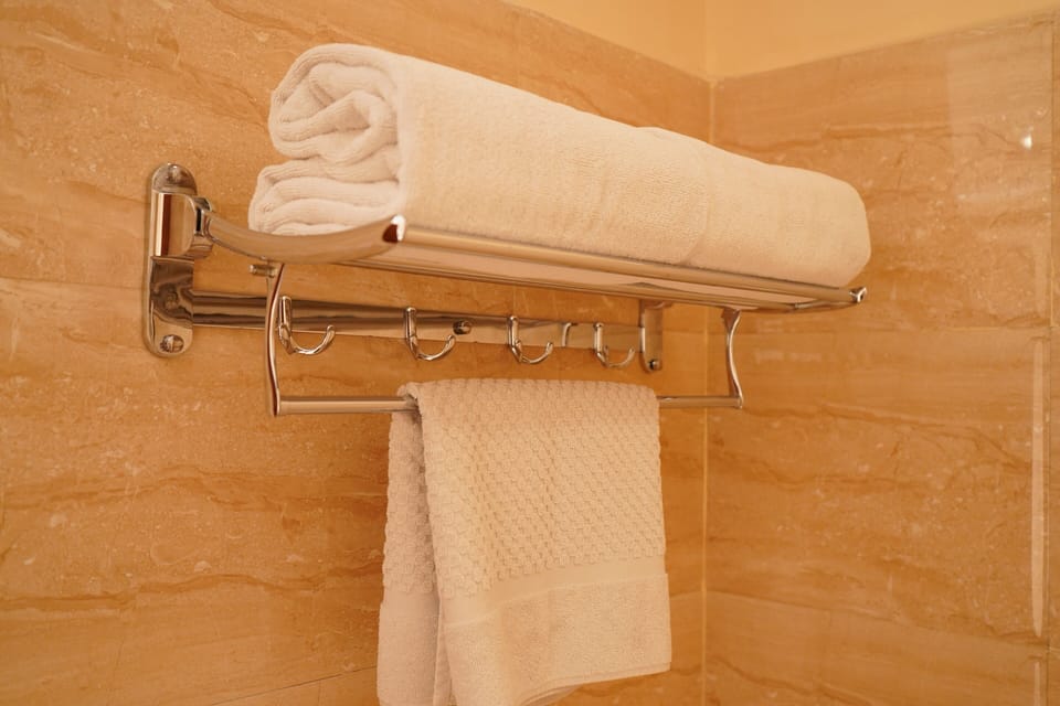 Shower, hair dryer, slippers, towels