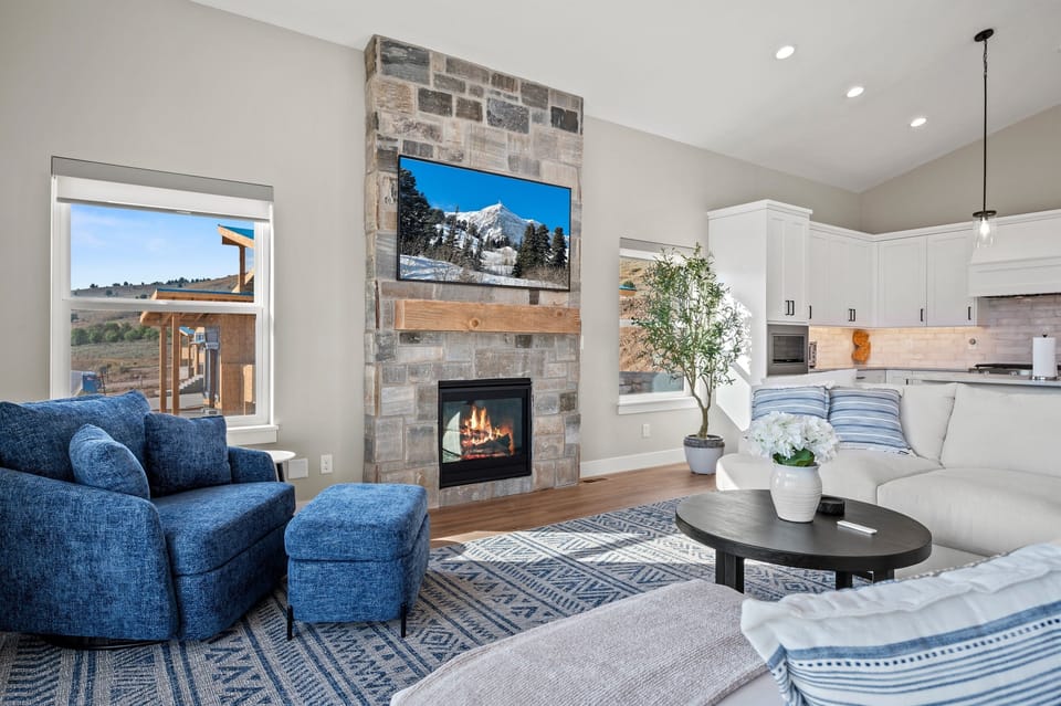 Relax by the warm glow of the fireplace or catch your favorite series on the large TV.