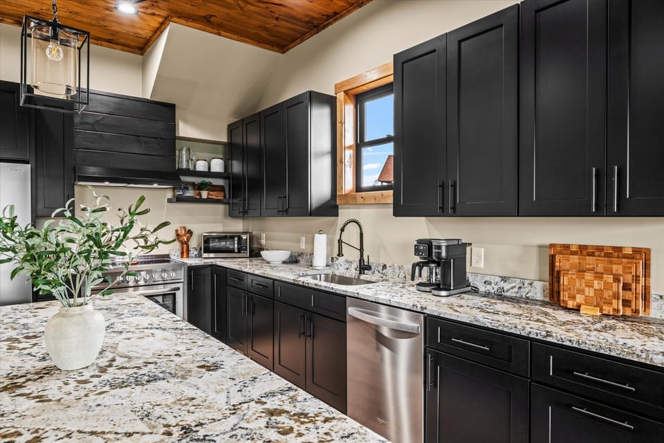 Modern black cabinetry and granite countertops make this kitchen as stylish as it is functional.