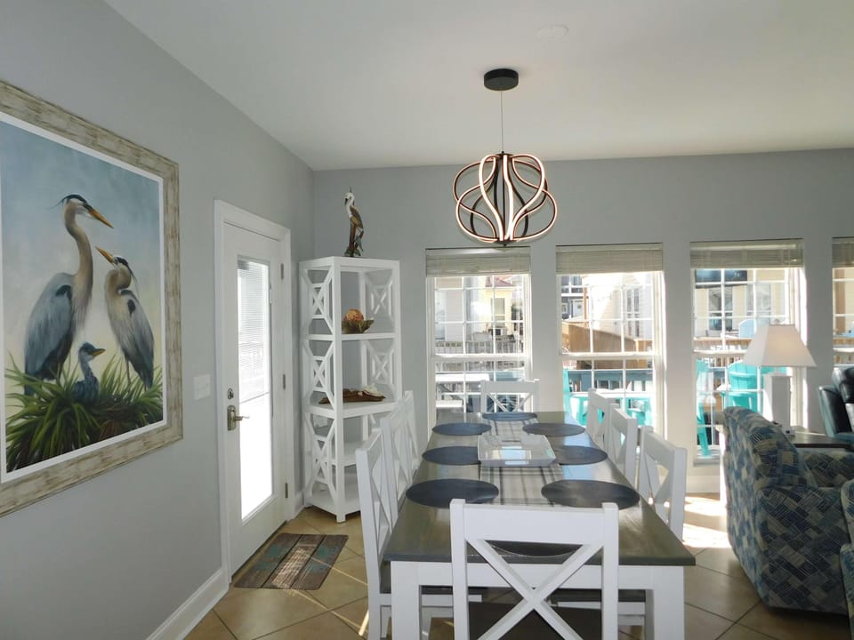 Bright dining area with coastal art and natural light