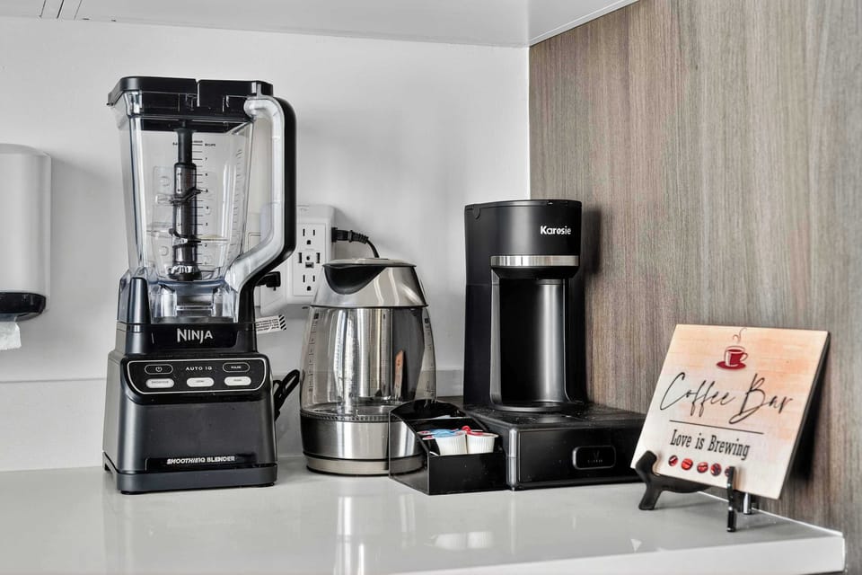 A dedicated coffee bar with a blender and coffee maker ready for your morning routine.