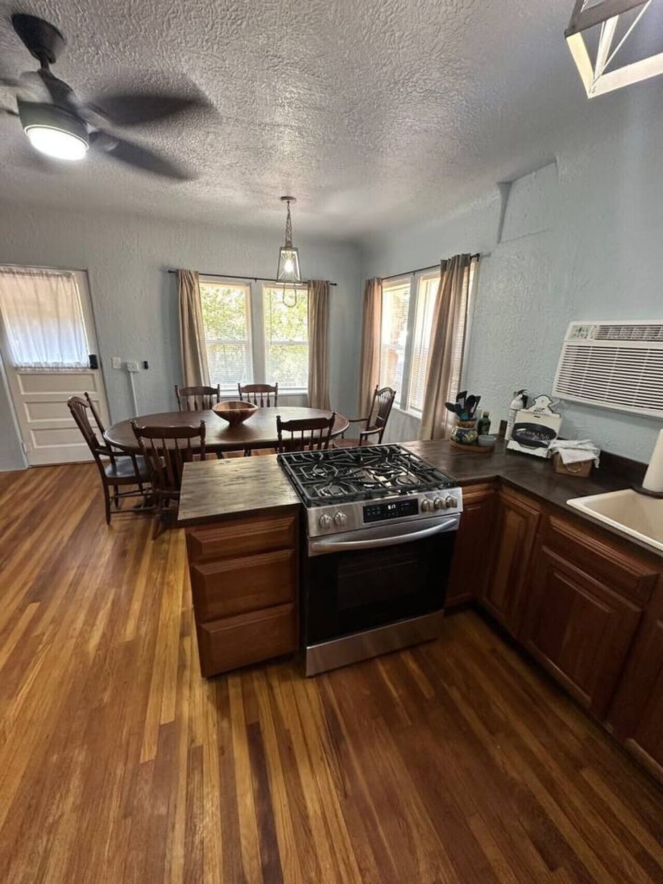 Guest will enjoy a full kitchen and a large solid wood dining table.