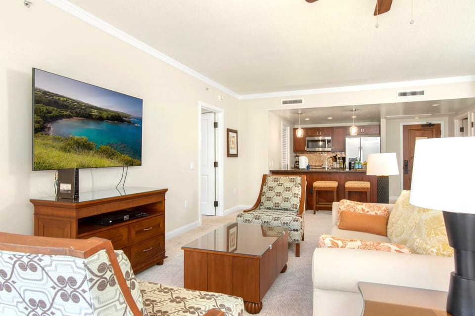 Spacious island suite with modern kitchen, cozy seating, and entertainment. HKK-343