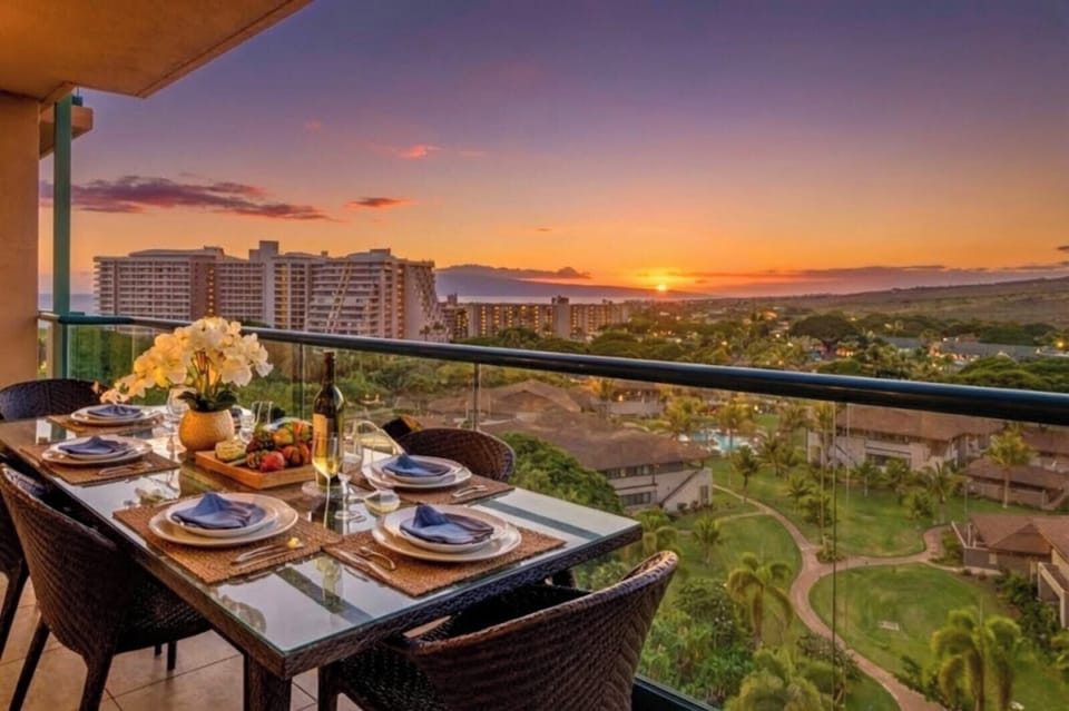 Dine outdoors as the sky glows at sunset, with Maui Mountain scenery and partial ocean views creating a memorable backdrop for evening meals. HKK-922