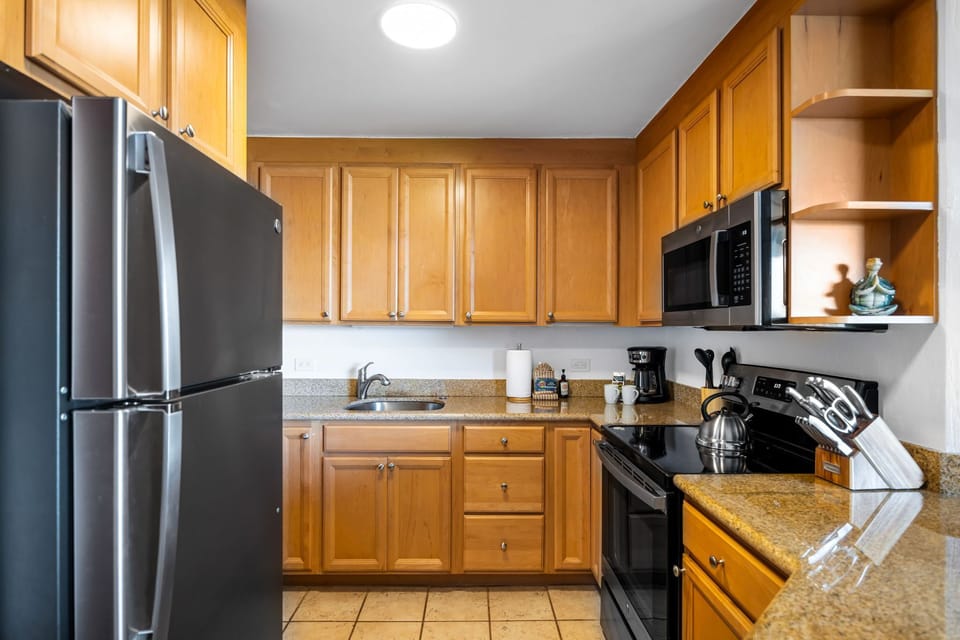 This fully equipped kitchen features granite countertops, full-size appliances, and ample cabinetry for easy vacation meal prep.