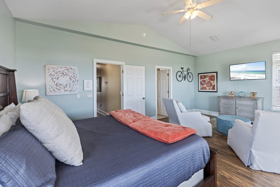 Sink into soft linens while gentle breezes from your ceiling fan keep you comfortable in this serene bedroom.