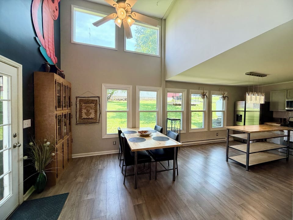     Bright dining area with soaring ceilings & natural light