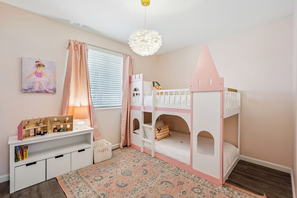 This adorable princess room is a special touch for the little ones. They will love the castle-style bunk beds