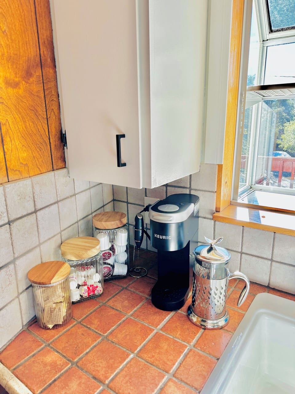 Coffee corner. Keurig machine with supplied pods, creamer and sugars. 