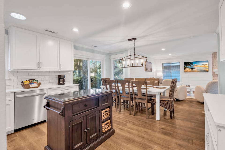 Seamlessly connected to the living area, the coastal kitchen embraces the light and airy aesthetic