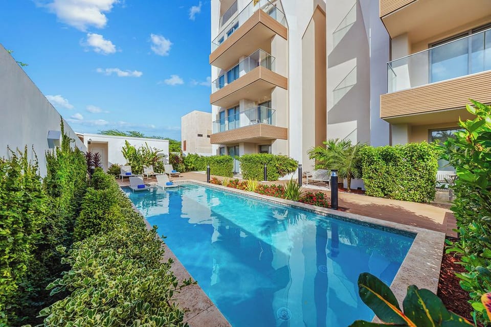 Enjoy our inviting shared pool area complete with a sunny patio, cushioned lounge chairs, and sun loungers—perfect for soaking up the rays or unwinding in style.