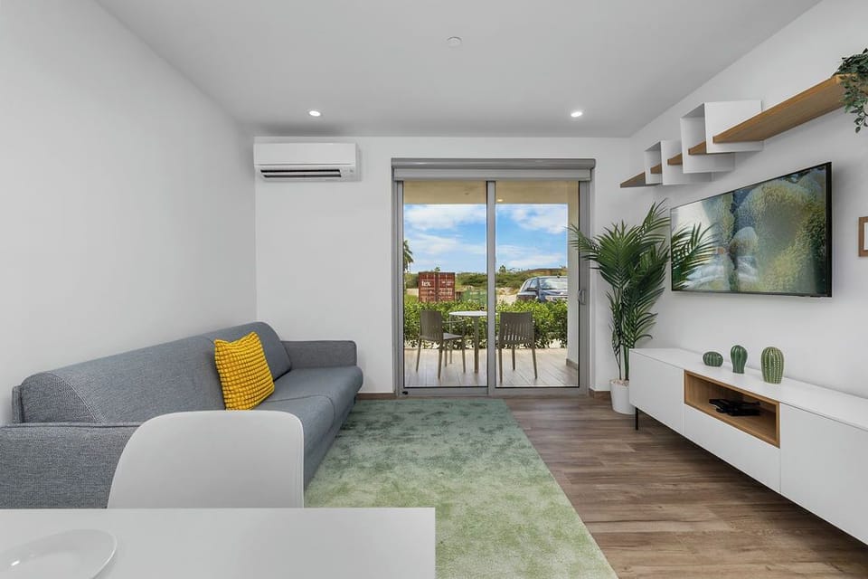 Our cozy living room is the perfect spot to unwind after a day of exploring. Enjoy a movie on the TV from the comfort of the plush sofa, stay cool with the AC, and easily step out onto the patio for some fresh air.